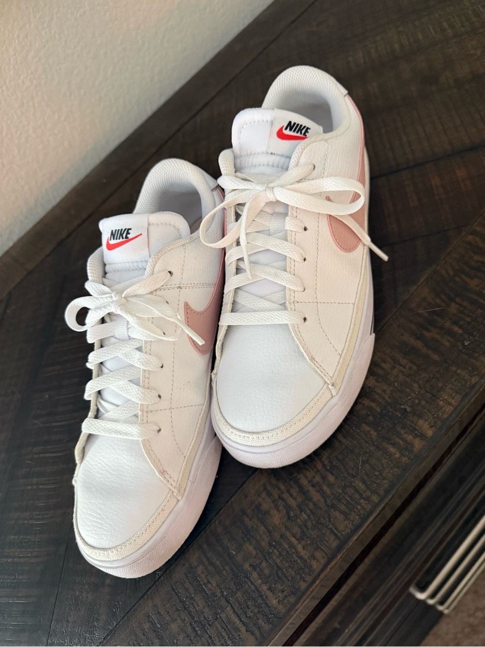 Nike Women's White Sneakers with Pink Swoosh Accent